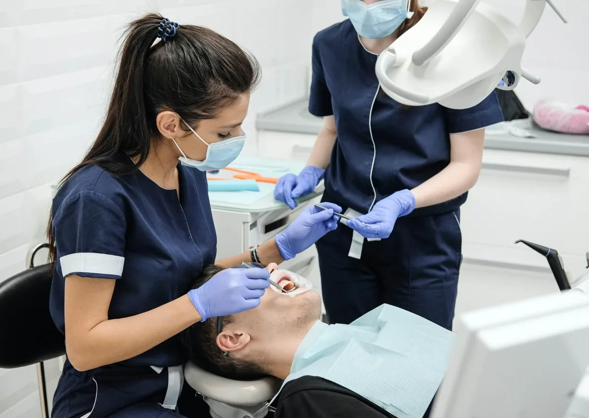 Dental team treating a patient while providing affordable dental implant care and treatment options.