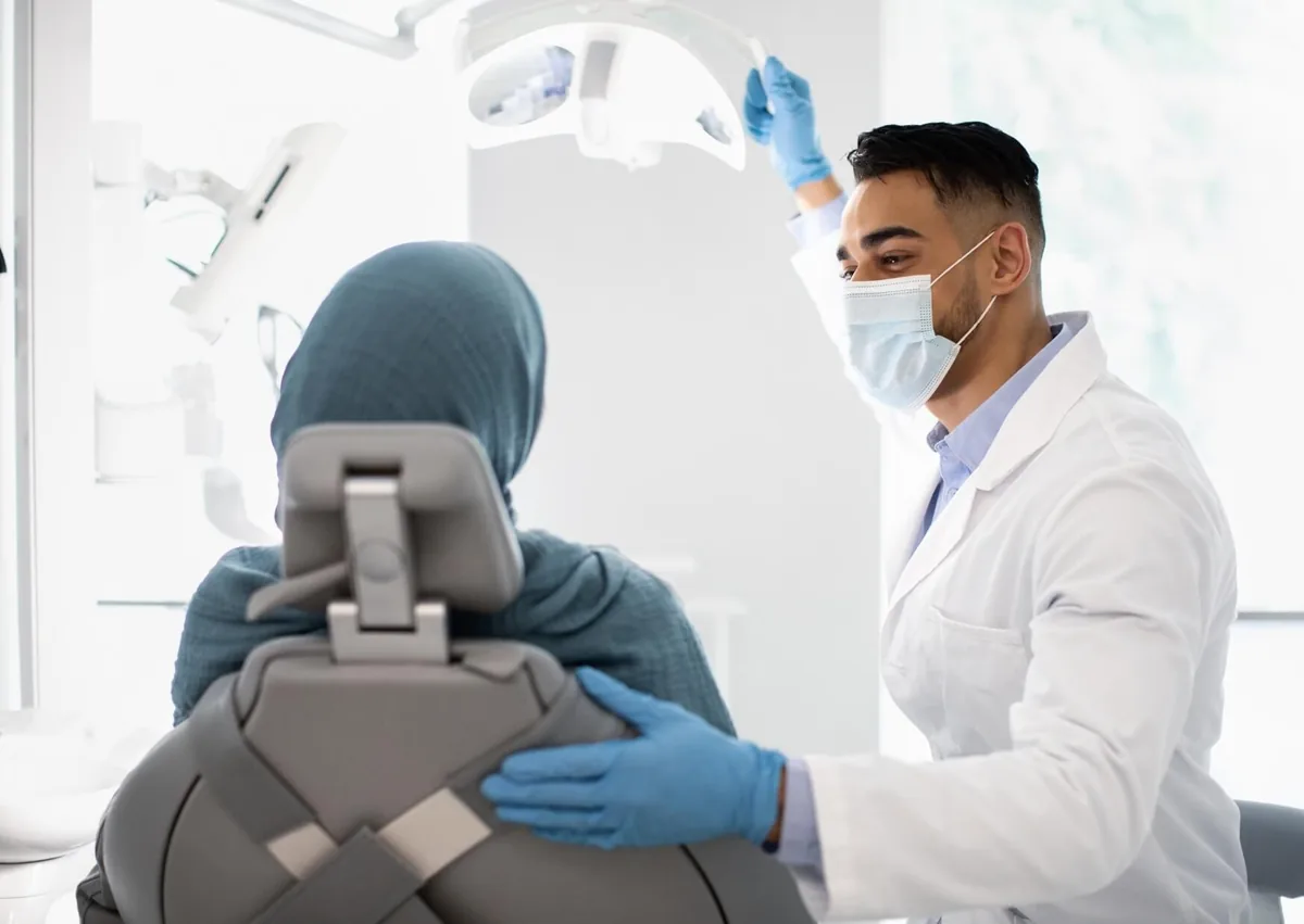 Dentist discussing cosmetic dentistry options with a patient during a consultation about treatment and cost.